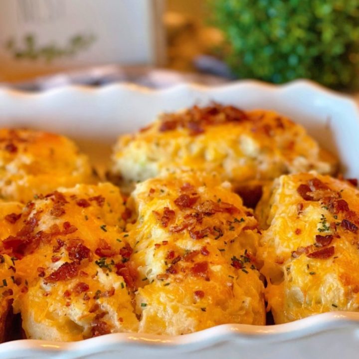 Best Every Loaded Twice Baked Potatoes nestled in a white casserole dish after coming out of the oven.