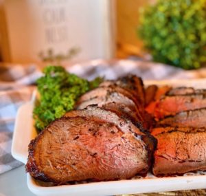 Sliced Grilled Tri-tip on a serving platter.