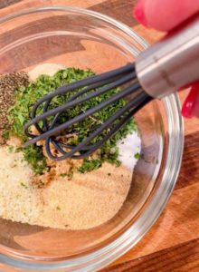 Using a small whisk to combine all the dry rub ingredients.