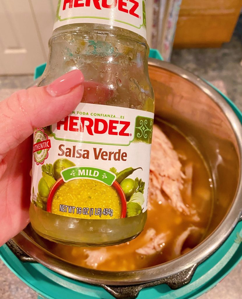 Holding a jar of Salsa Verde for the Corn Chowder.