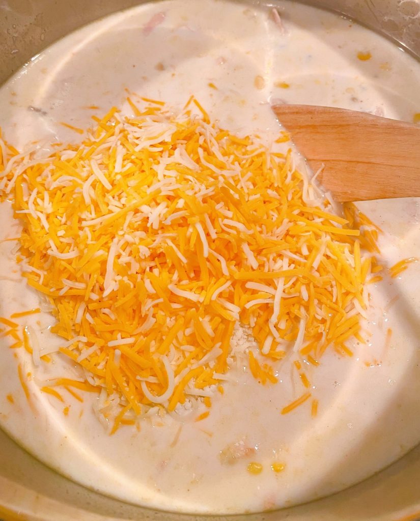 Shredded Cheese being added to Chowder.