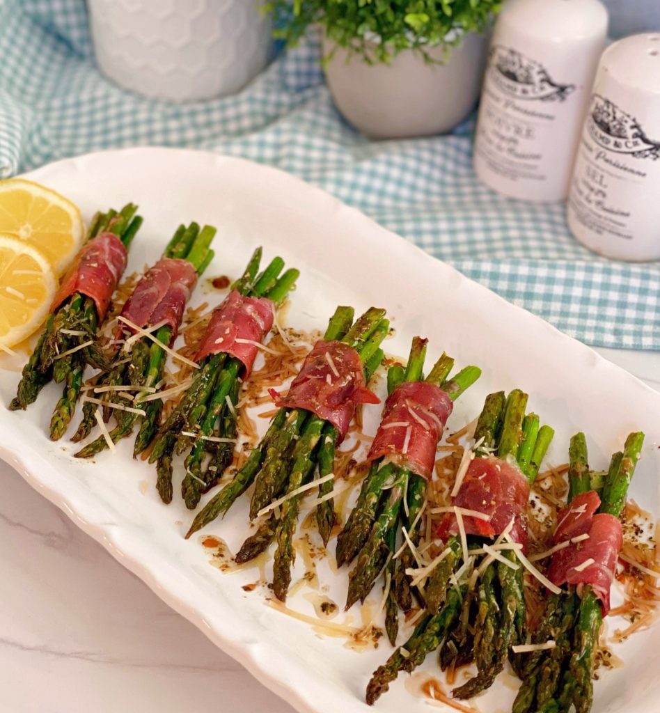 Prosciutto-Wrapped Asparagus on a plate with Balsamic Drizzle.