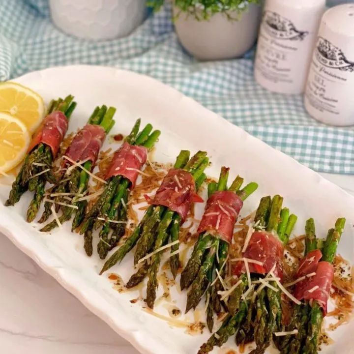 Prosciutto-Wrapped Asparagus on a plate with Balsamic Drizzle.