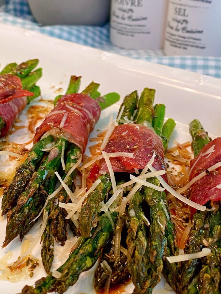 Asparagus Bundles on a serving platter with balsamic glaze.