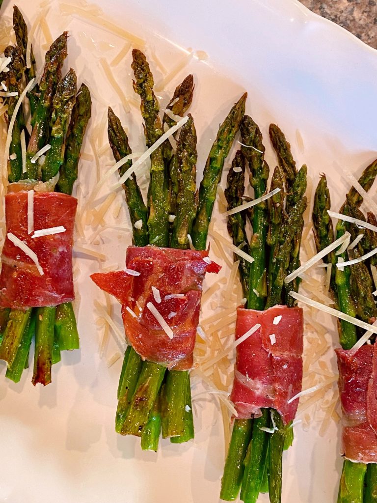 Sprinkling Asparagus with Parmesan Cheese.