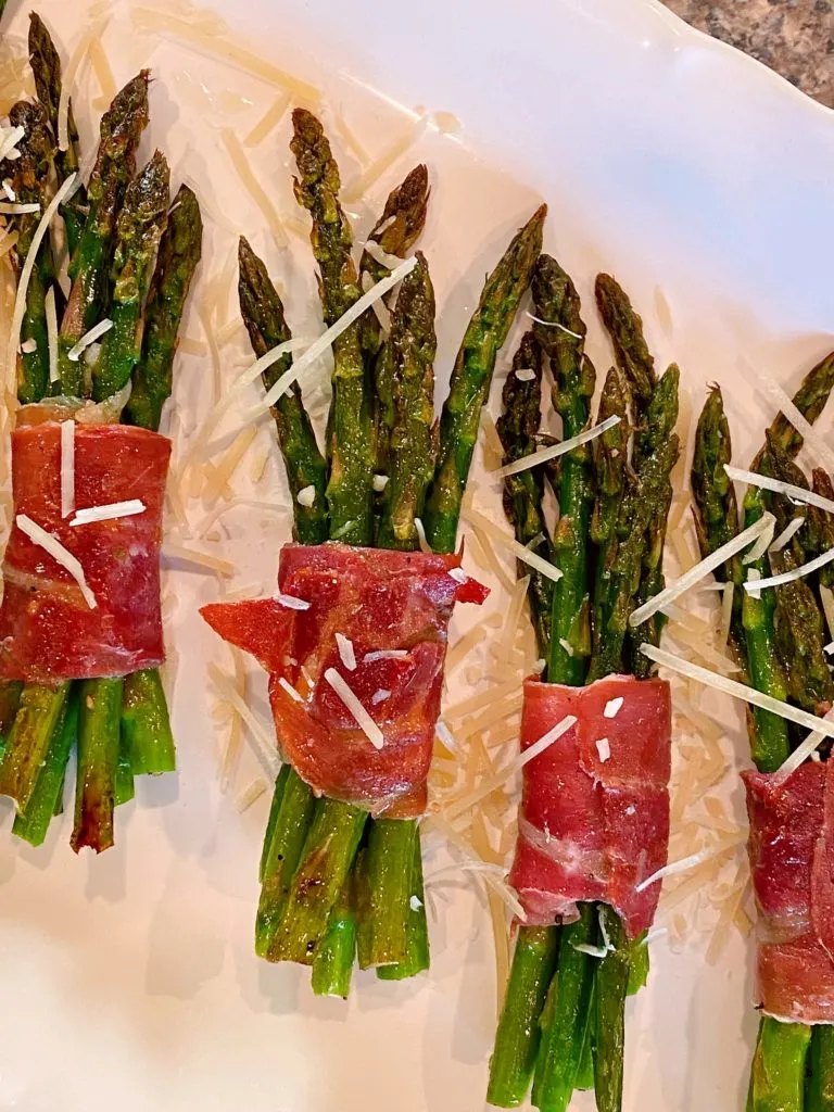 Sprinkling Asparagus with Parmesan Cheese.