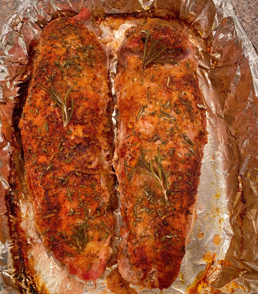 Baked Pork Tenderloin in foil covered baking dish.