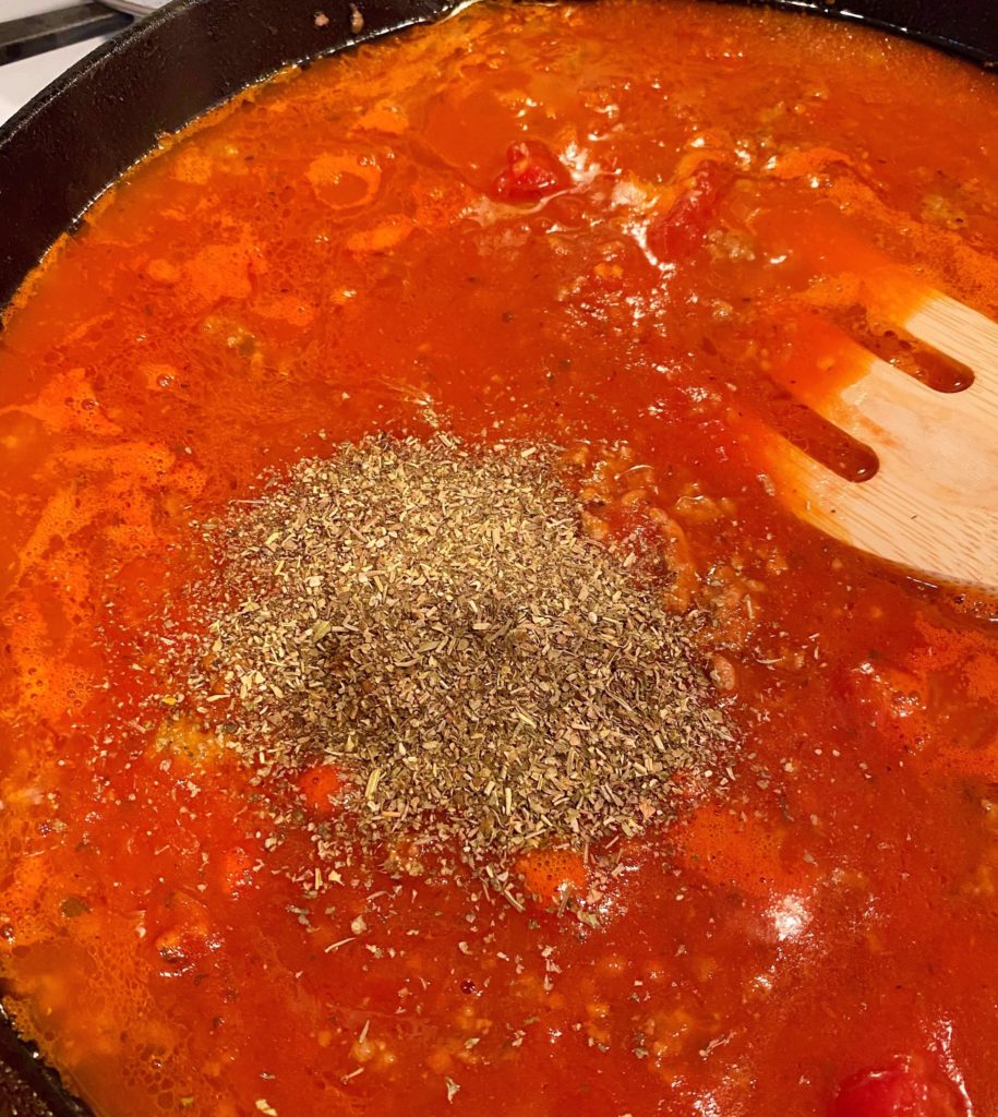 Addition of Italian Seasonings to sauce.