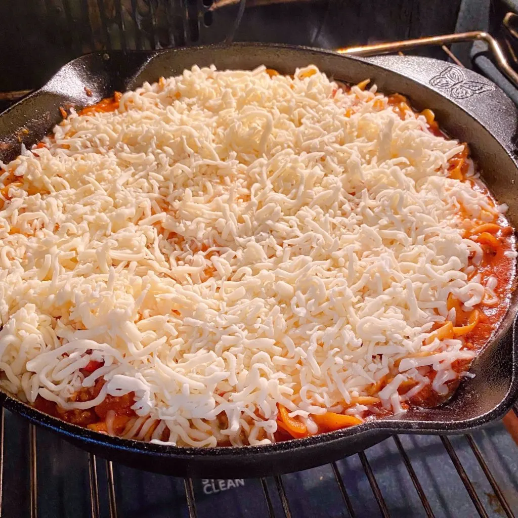 Skillet Lasagna covered with shredded mozzarella cheese.