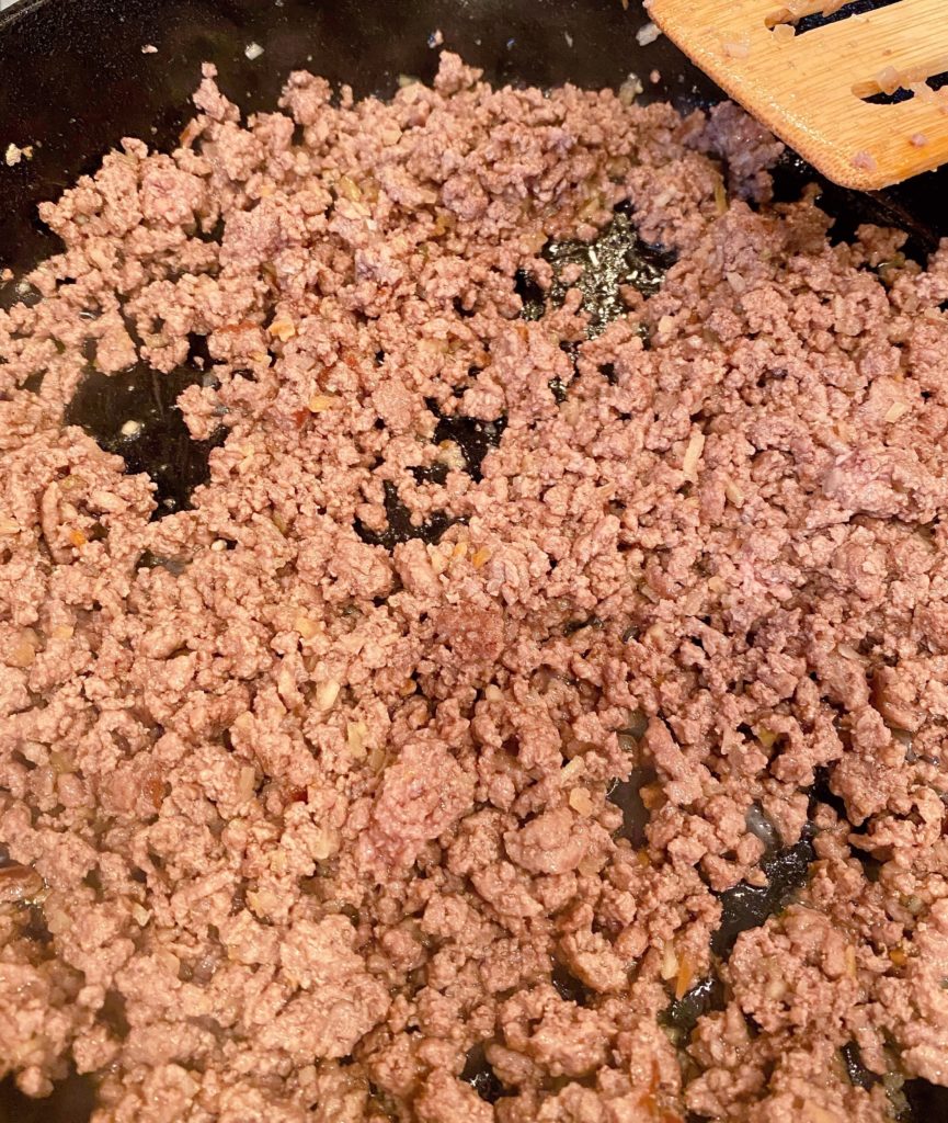 Ground beef browning in Cast Iron Skillet.