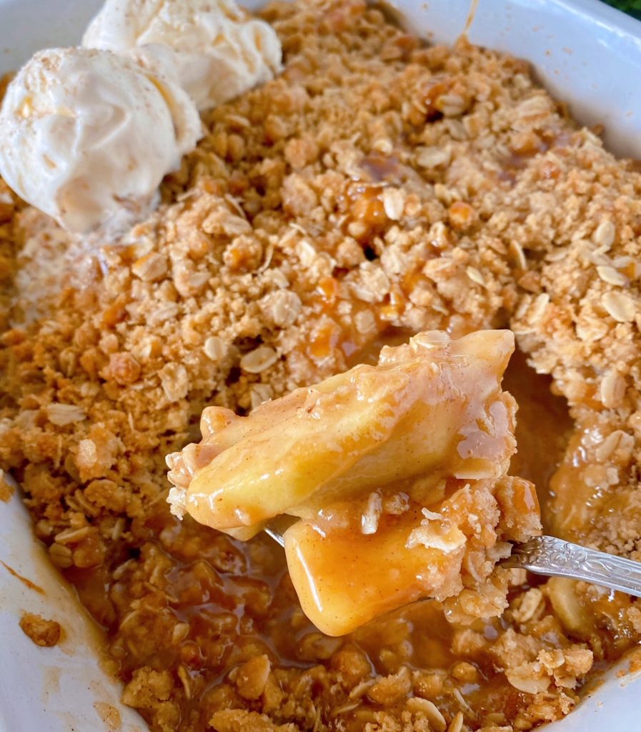 Apples from Apple Crisp speared on a fork after baking straight out of the casserole dish.