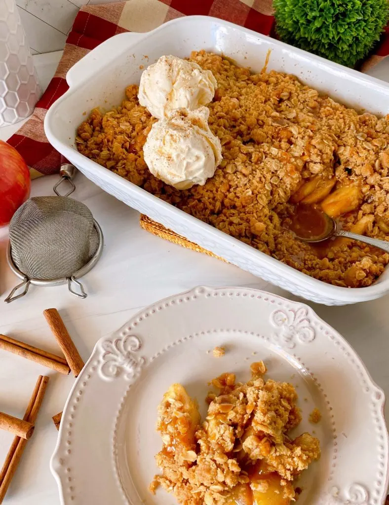 Apple Crisp in baking dish with a serving to the side.