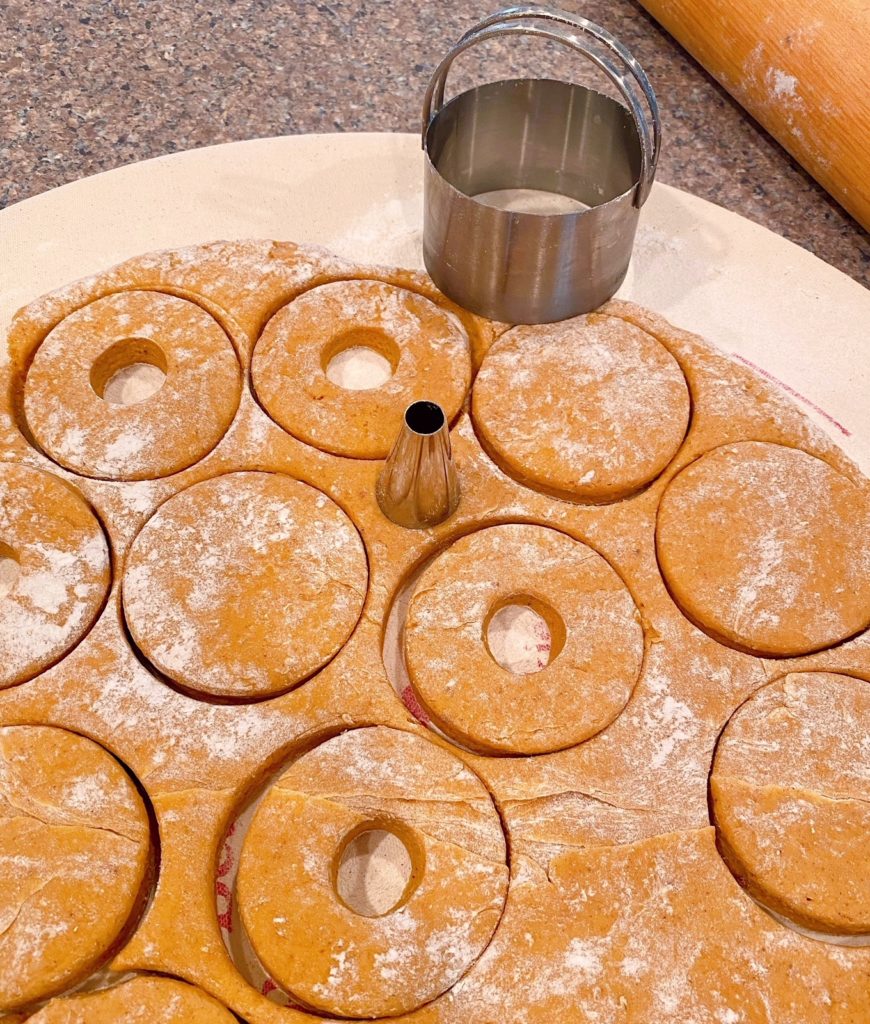 Pumpkin Dough rolled out and cut into donut shapes.