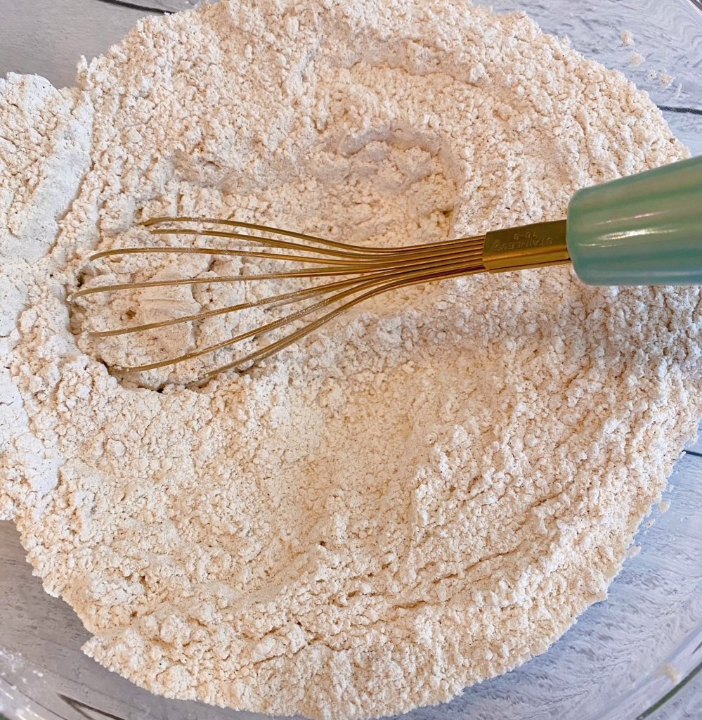 A large bowl with dry ingredients whisked together.