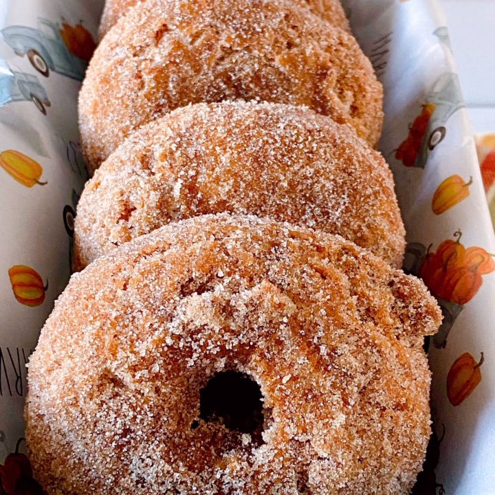 Pumpkin Spice Donuts with cinnamon sugar in a pan.