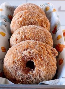 Pumpkin Spice Donuts with cinnamon sugar in a pan.