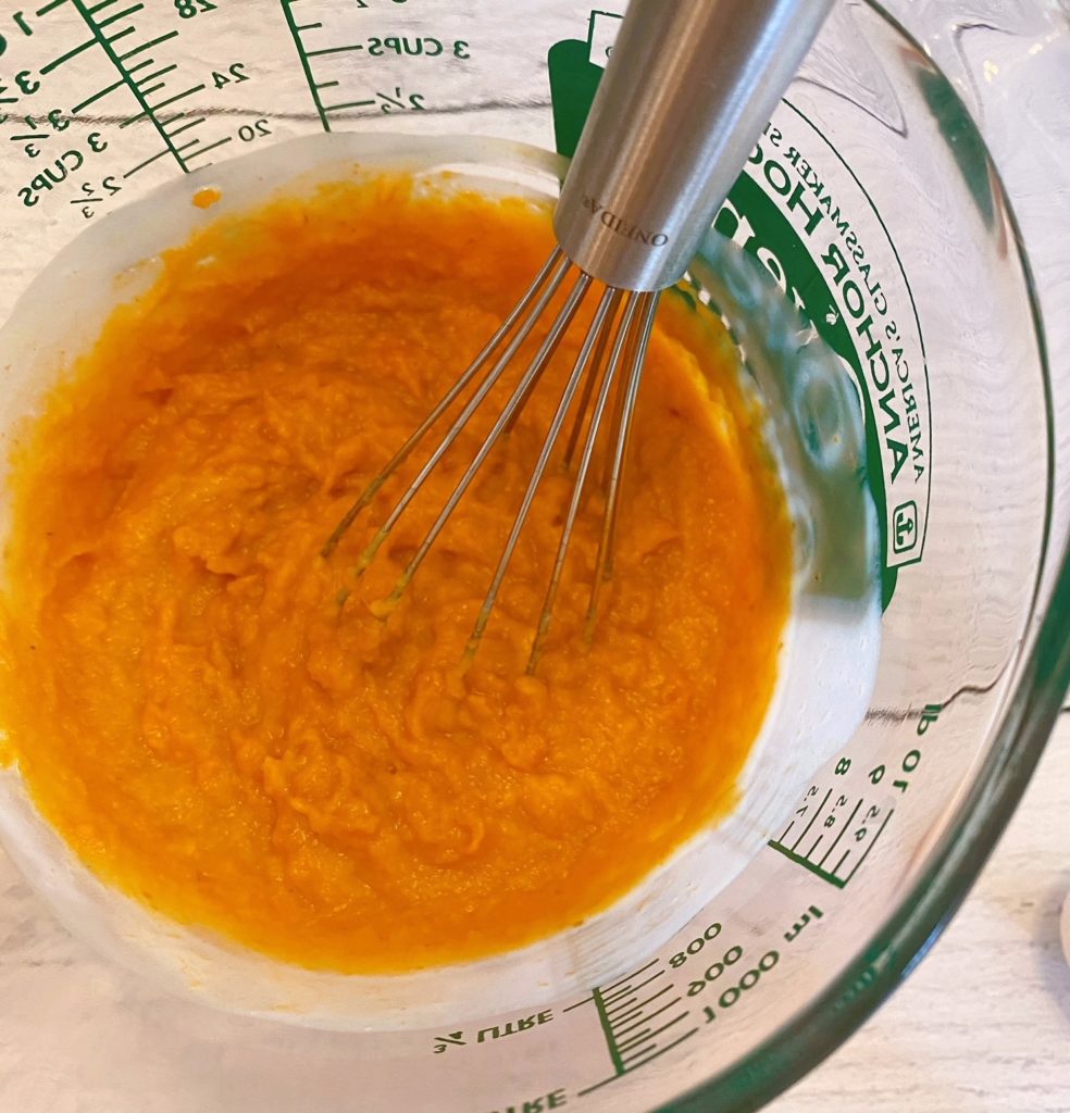 Combining buttermilk and pumpkin in large liquid measuring cup.