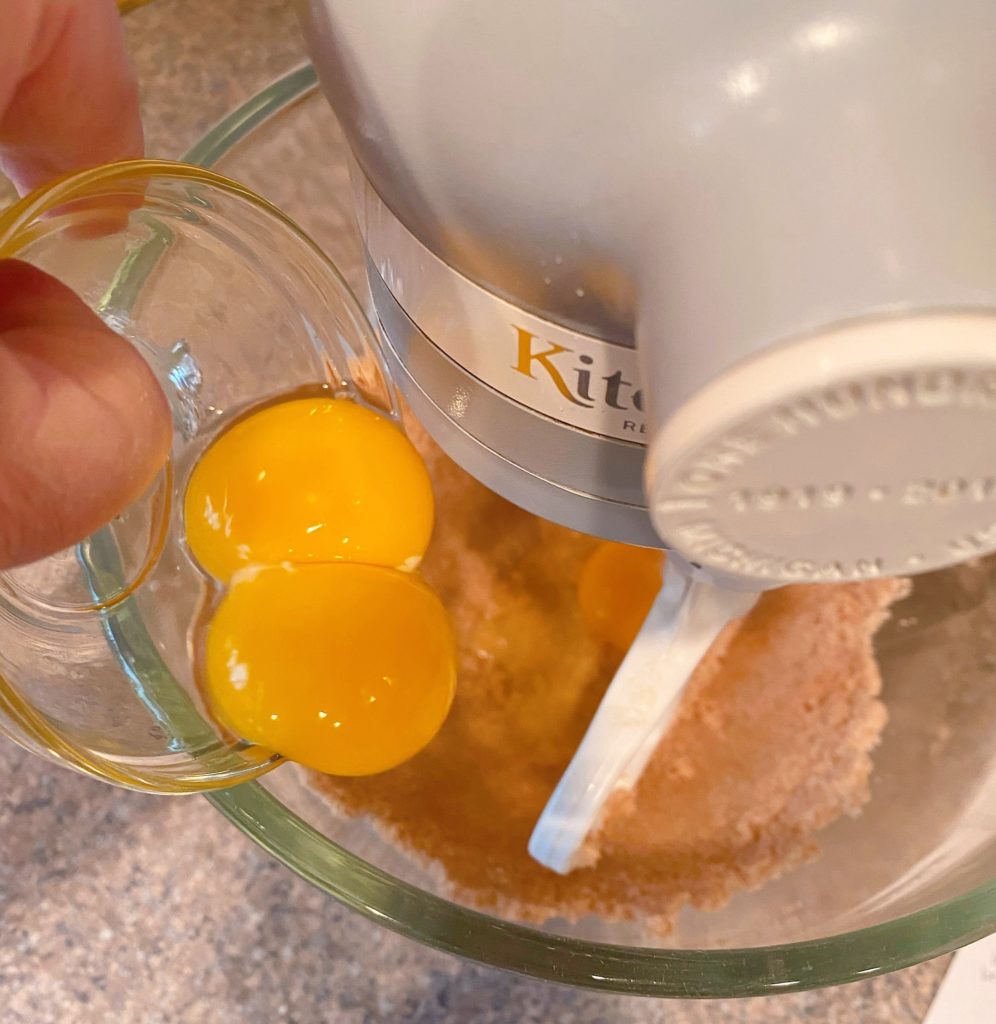 Adding the Eggs to the creamed butter and sugar.