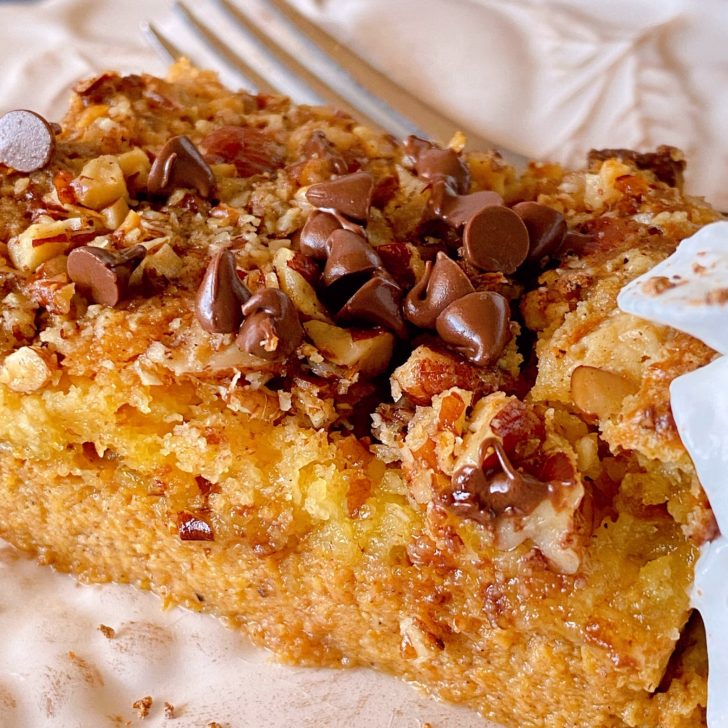 Slice of Pumpkin Dump Cake on a plate with a fork.