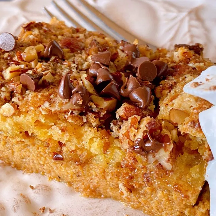 Slice of Pumpkin Dump Cake on a plate with a fork.