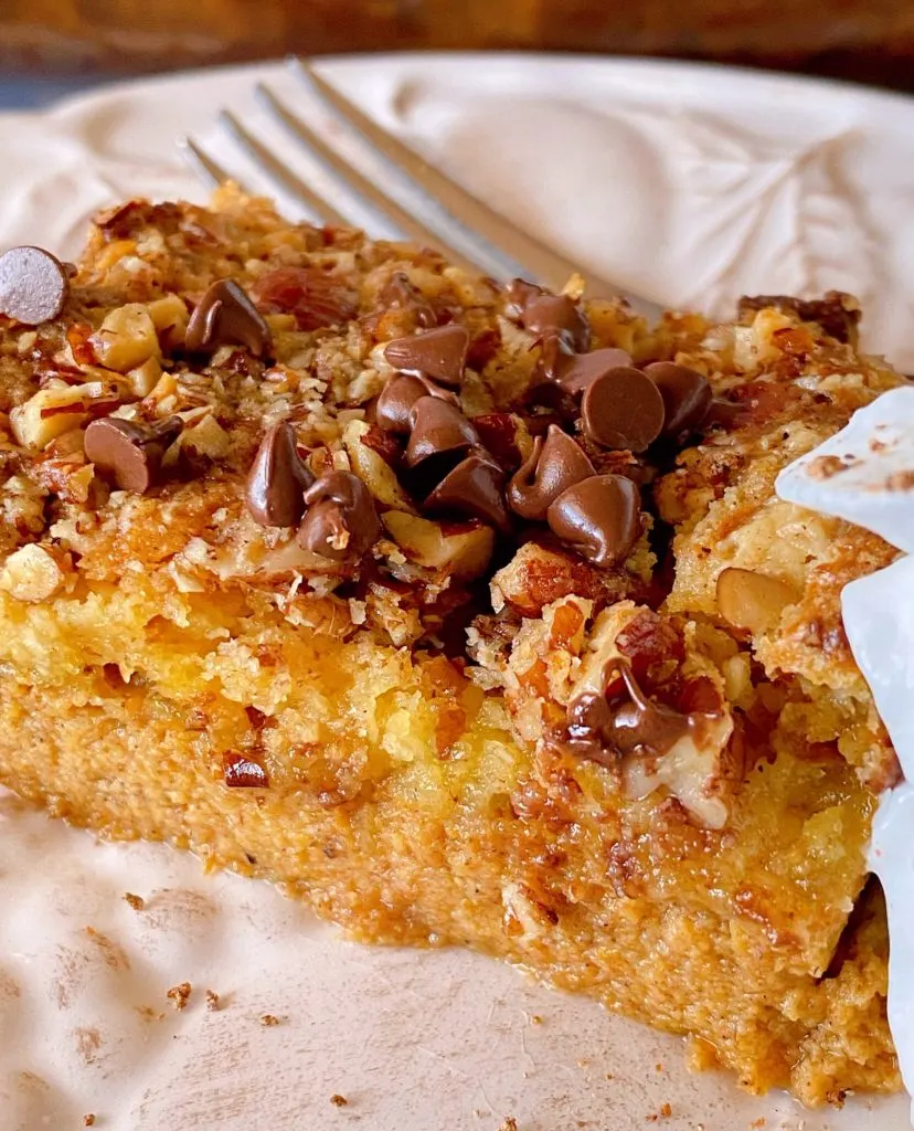 Slice of Pumpkin Dump Cake on a plate with a fork.