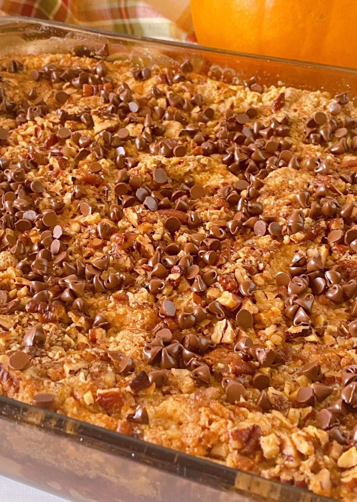 Chocolate Chips sprinkled over the top of baked Pumpkin Dump Cake.