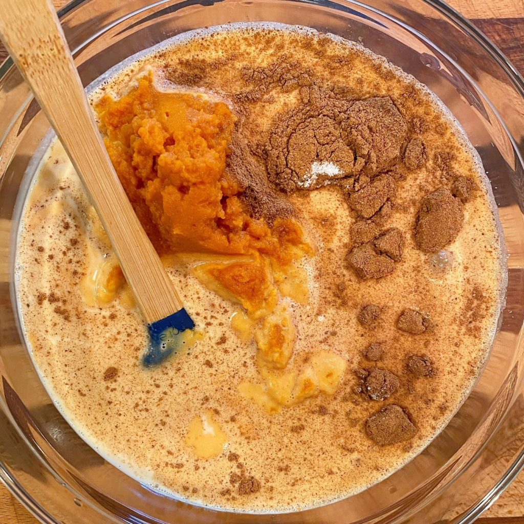 Pumpkin Filling ingredients in a large bowl with a spatula waiting to be mixed.
