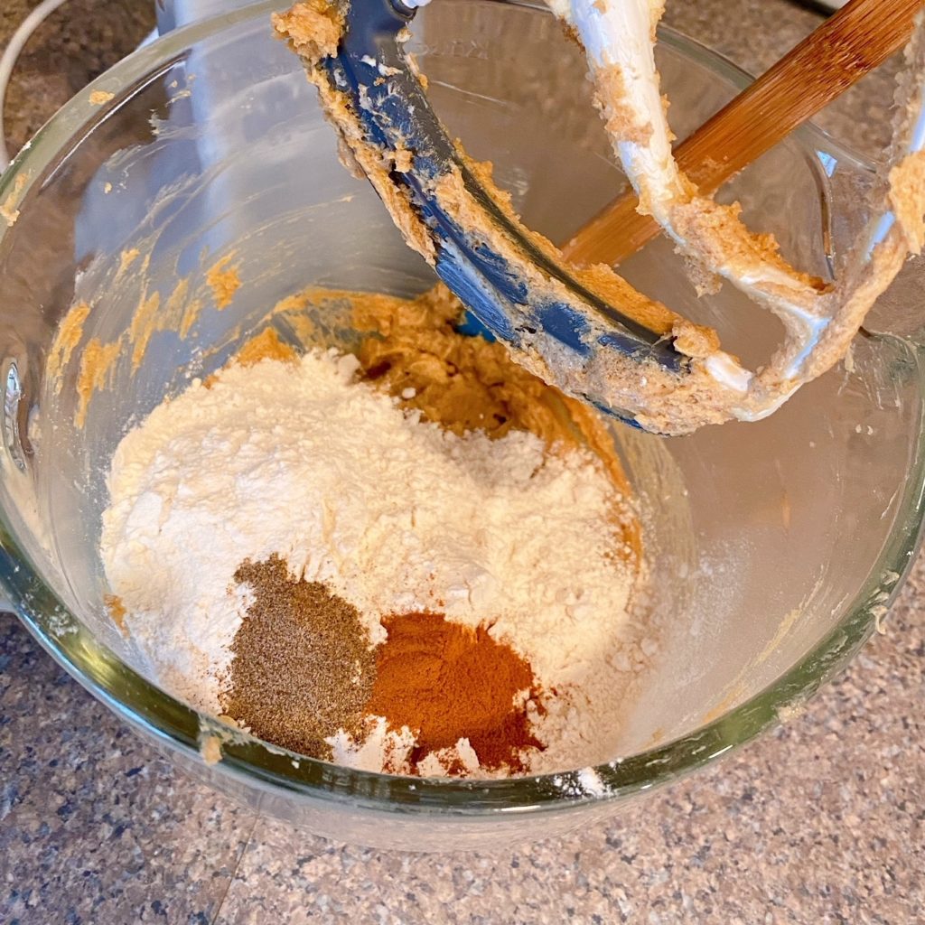 Adding flour, cinnamon and cardamom in with butter, and sugar.