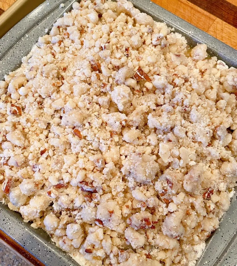 Crumb Topping sprinkled over the top of fruit cobbler ready to bake.