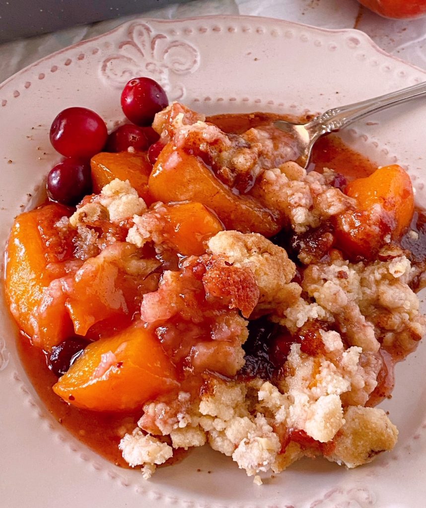 Up close photo of Peach Cranberry Cobbler on a dessert plate.