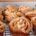 Close-up photo of Cruffins on a baking rack cooling.