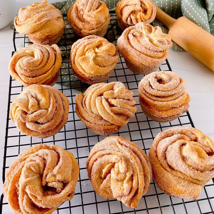 Cruffins on a baking sheet cooling.