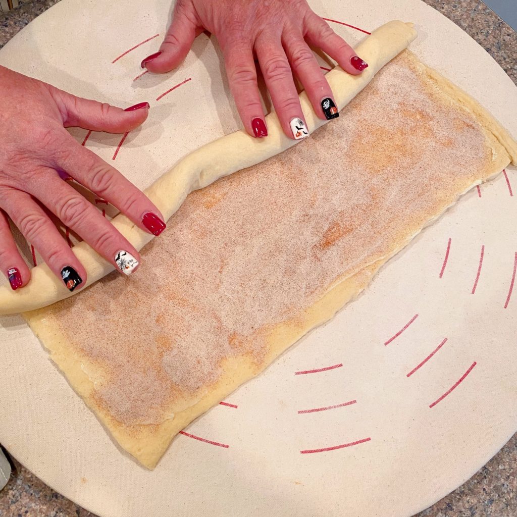 Rolling crescent dough into a log.