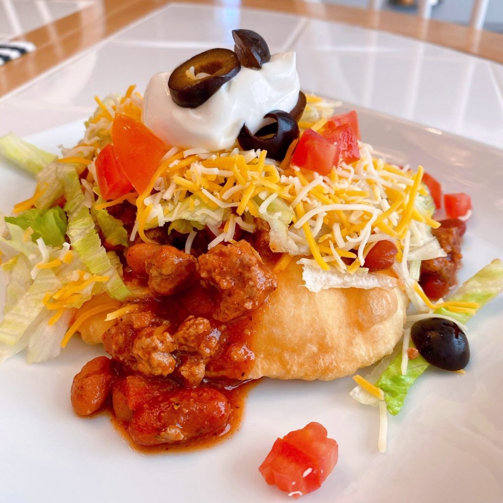 Indian Fry Bread Tacos on a white plate.