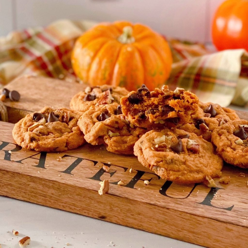Cutting board loaded with Pumpkin Chocolate Chip Cookies.