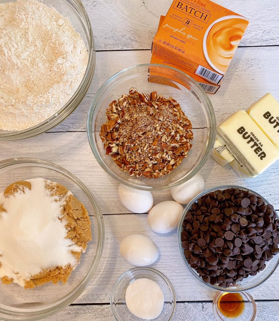 Ingredients for Pumpkin Chocolate Chip Cookies on a white board.