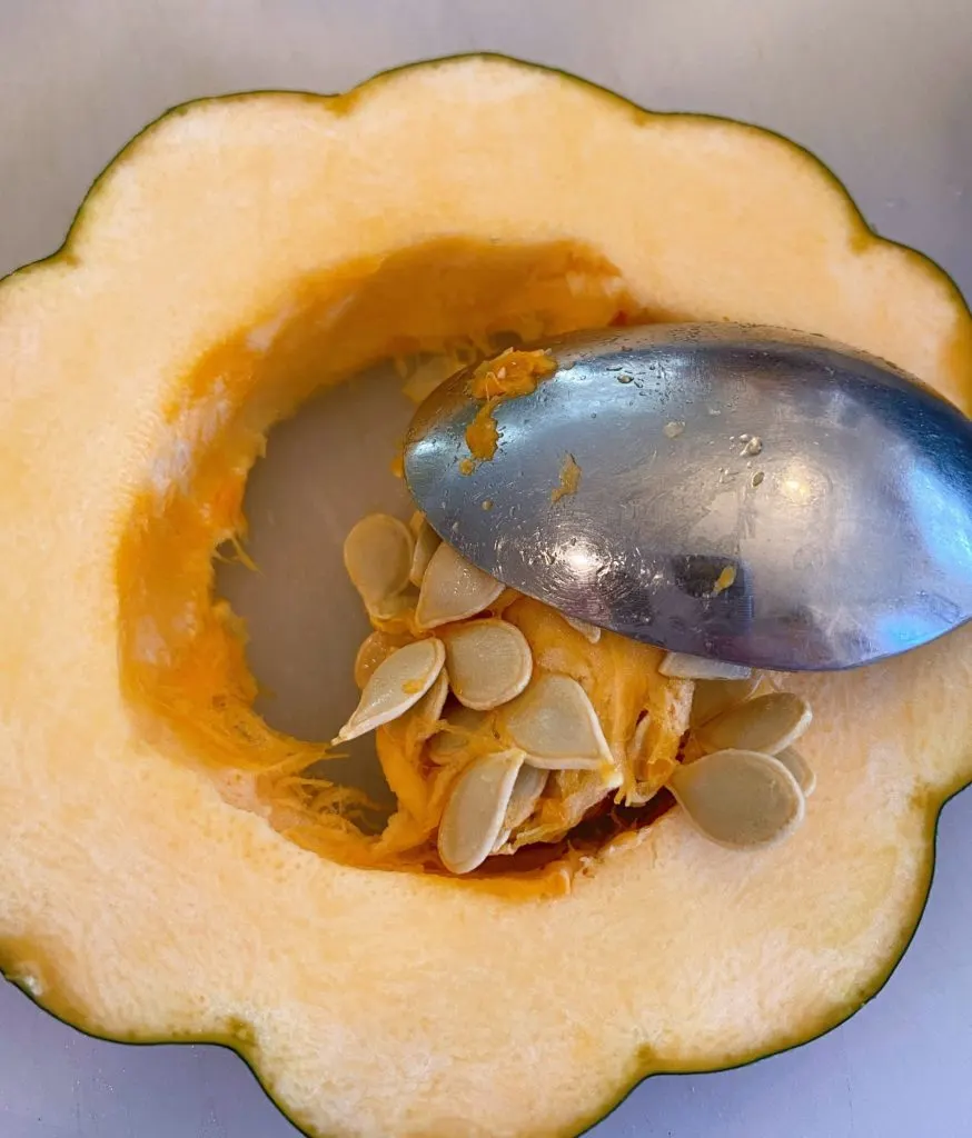 Removing seeds from squash for roasting.