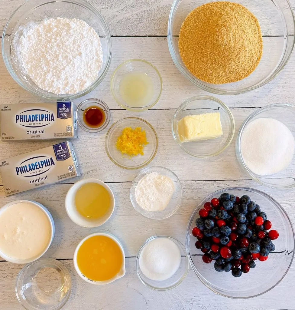 All of the ingredients for Cranberry Blueberry Pie on a white board.