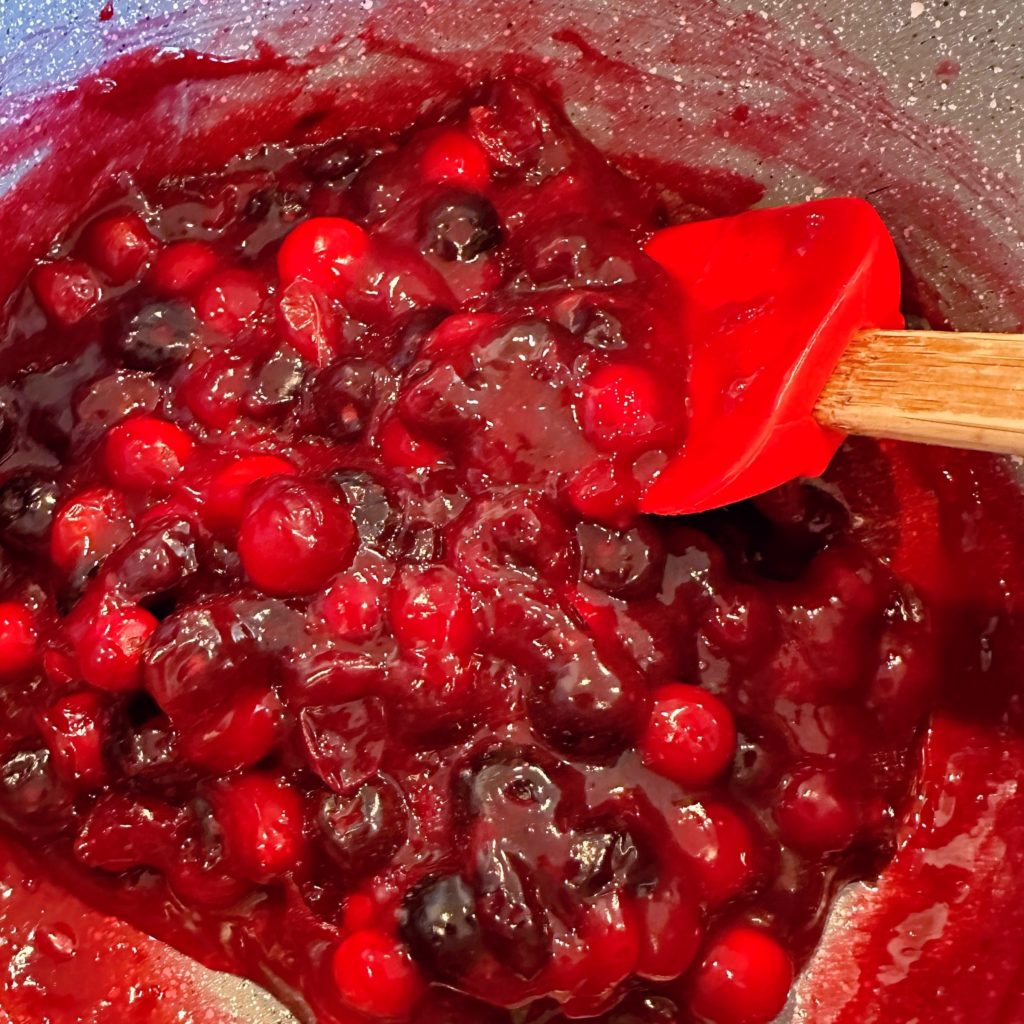 Cranberry and Blueberry topping thickened in the sauce pan on the stove top. 