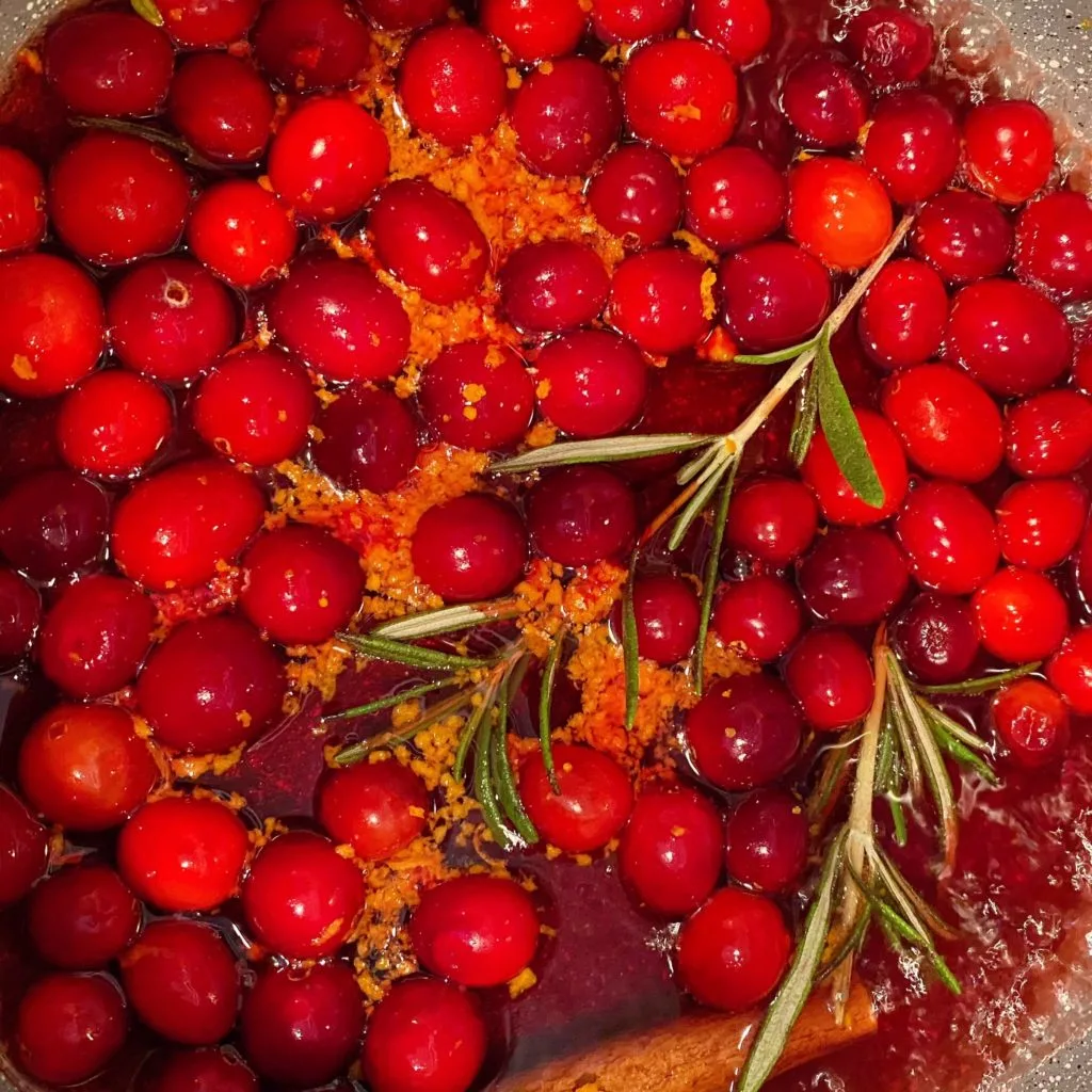 Cranberry Sauce in a sauce pan boiling on the stove top.