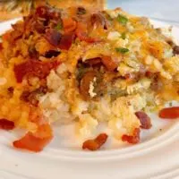 Loaded Tater Tot Breakfast Casserole on a white serving plate.