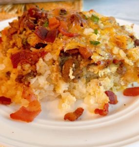 Loaded Tater Tot Breakfast Casserole on a white serving plate.