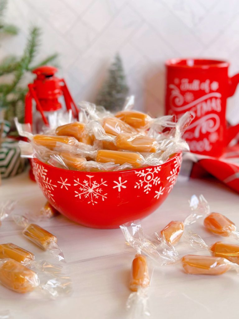 Homemade Caramels wrapped and in a red candy dish.