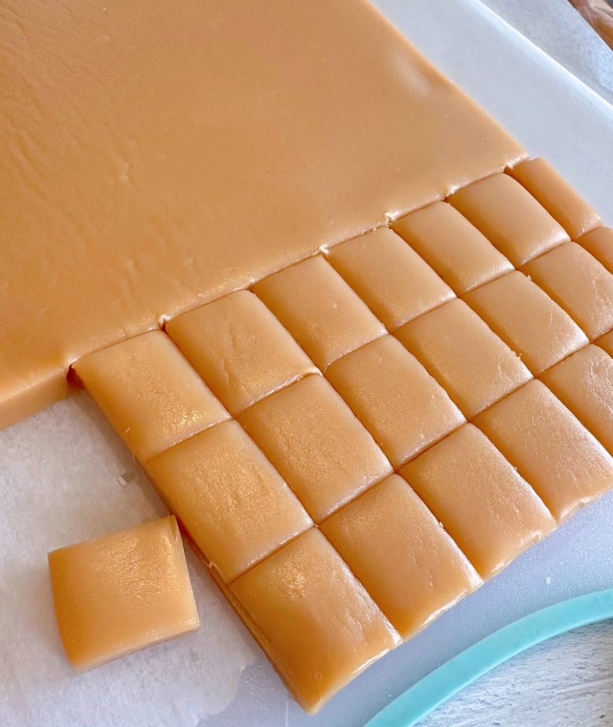 Caramels cut into squares for wrapping.