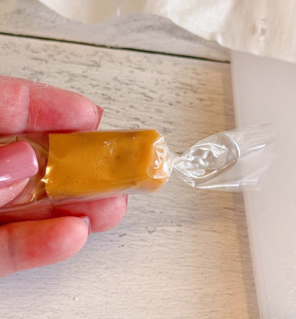 Wrapping caramels in cellophane candy wrappers.