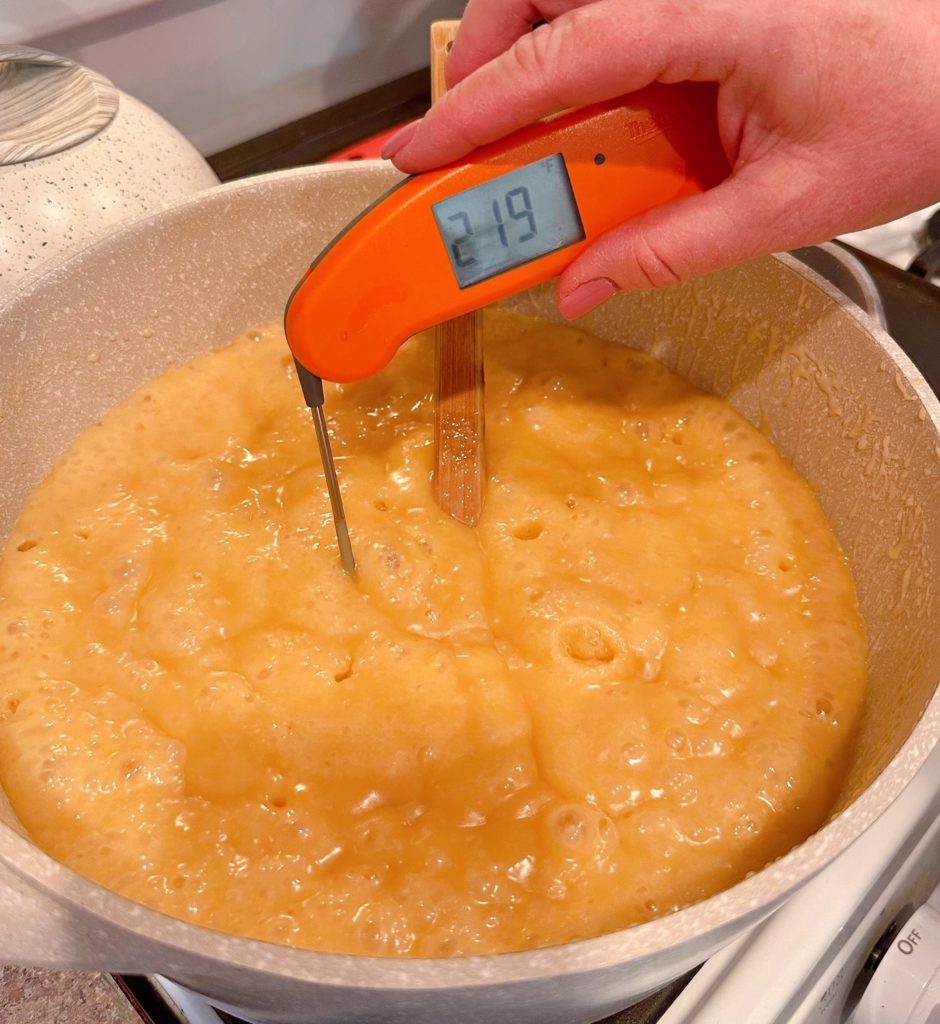 Checking Caramel with digital thermometer.