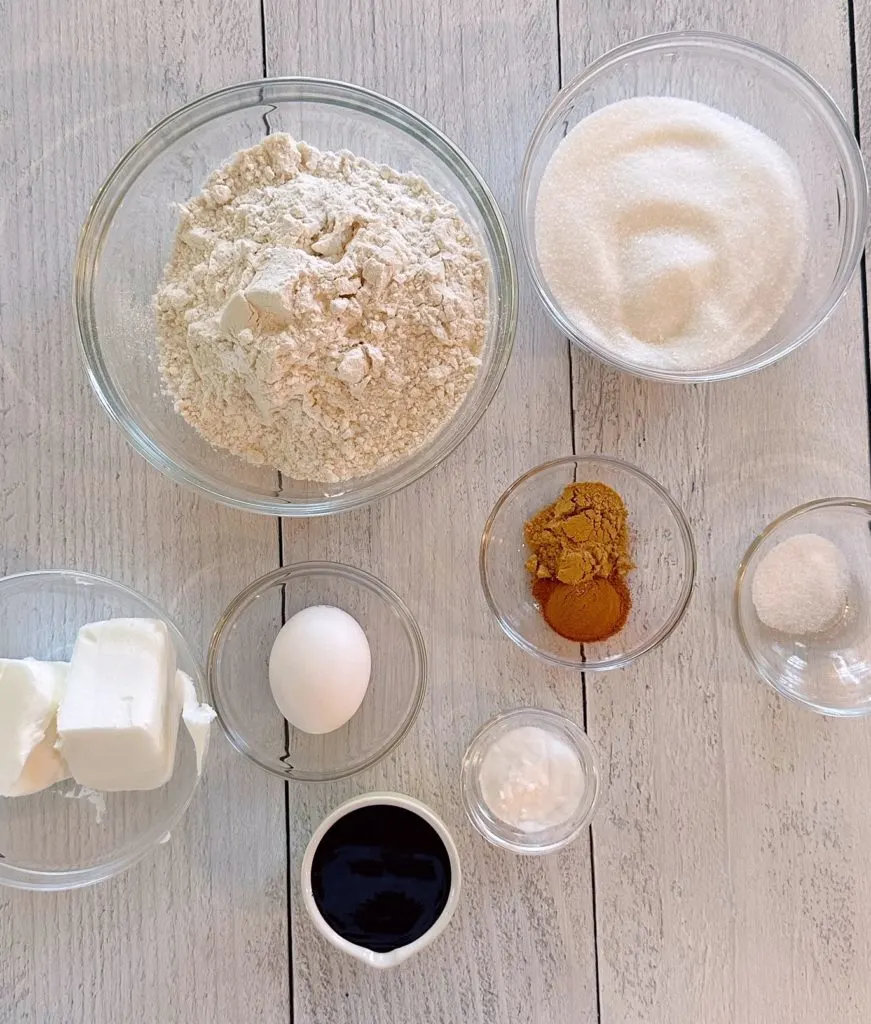 Ingredients for Molasses Gingersnap Cookies on a white board.