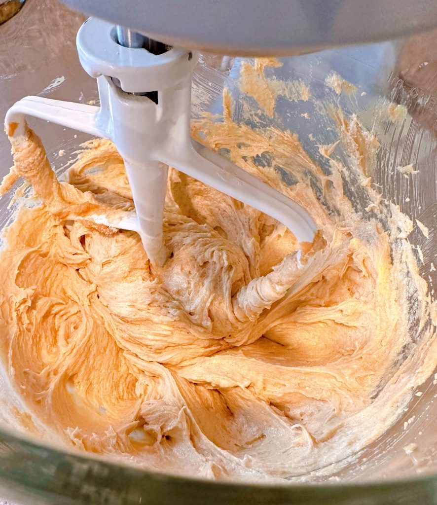 Butter, sugars, and peanut butter in bowl of stand mixer whipped until fluffy.