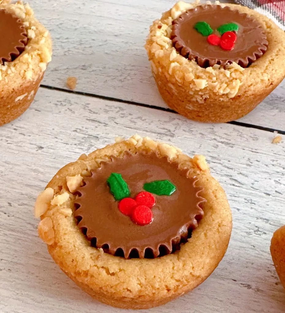 Close-up shot of individual Peanut Butter Cup cookie decorated with Holly Sprinkles.