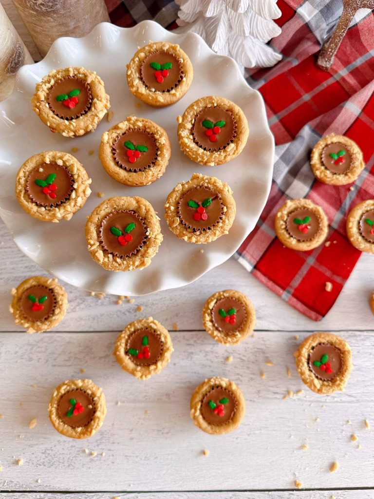 Overhead shot of Christmas Peanut Butter Cup Cookies on a white cake plate.